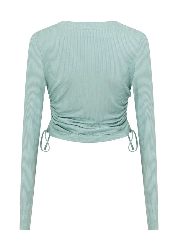 Discover the perfect blend of style and comfort with this long sleeve top, your new must have wardrobe essential. Crafted from a soft and breathable viscose blend rib fabrication, the adjustable drawcord sides allow you to customise your look, making it perfect for wearing back with your active as well as everyday looks. With thumbholes to secure your sleeves while training, this really is the perfect winter base layer.