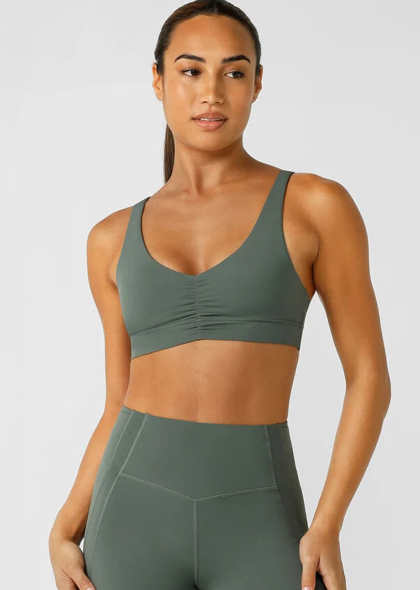 Unlock your potential in this high support sports bra. Made from LJ's sweat-wicking Recycled Bare Minimum™ fabric, this bra features adjustable back strapping that you can wear two ways (straight straps, or cross-back), so you can adjust your support level as needed.