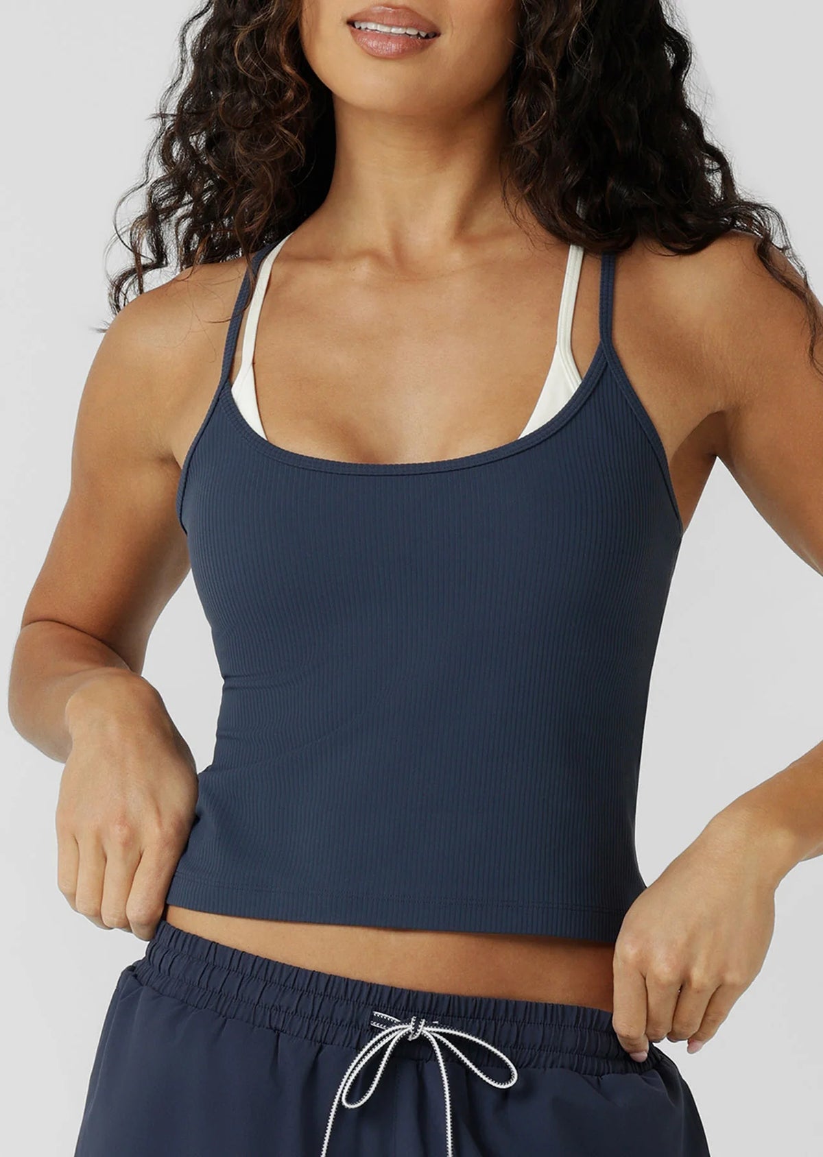 Built In Shelf Bra with Removable Padding for All Day Support
Fashion Forward Layered Look Design
Form Flattering Full Length Fitted Silhouette
Sweat wicking Luxe Active Rib Fabrication
Woven Logo Badge