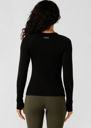 Up the tempo in this seamless long sleeve top designed to move with you - from low to max intensity workouts. Engineered in our 8-way stretch ultra soft seamless technology, this flattering full length top features strategically placed breathable panels to help you stay cool when your workout heats up. Designed with thumbholes to secure your sleeves, and a reflective iconic logo for extra visibility on those late-night workouts and early morning runs, this versatile active layering piece is bound to become 