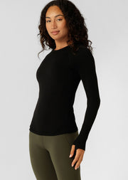 Up the tempo in this seamless long sleeve top designed to move with you - from low to max intensity workouts. Engineered in our 8-way stretch ultra soft seamless technology, this flattering full length top features strategically placed breathable panels to help you stay cool when your workout heats up. Designed with thumbholes to secure your sleeves, and a reflective iconic logo for extra visibility on those late-night workouts and early morning runs, this versatile active layering piece is bound to become 