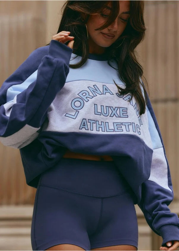 Stay cozy and stylish in this oversized sweat, featuring tonal color-blocked panels and statement logo embroidery. Perfect for lounging and running errands, this sweat is a must-have addition to your casual wardrobe, providing comfort and warmth when you need it most.