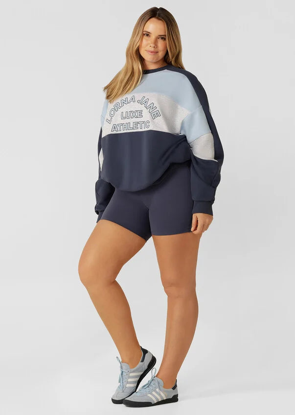 Stay cozy and stylish in this oversized sweat, featuring tonal color-blocked panels and statement logo embroidery. Perfect for lounging and running errands, this sweat is a must-have addition to your casual wardrobe, providing comfort and warmth when you need it most.