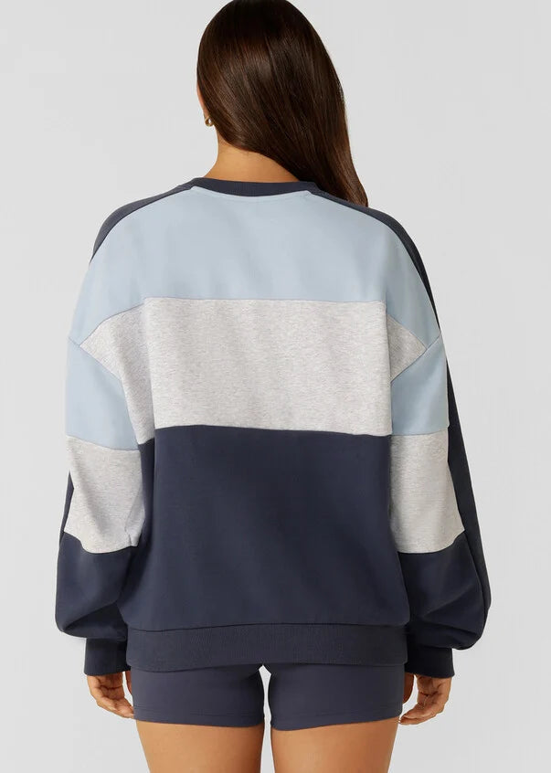 Stay cozy and stylish in this oversized sweat, featuring tonal color-blocked panels and statement logo embroidery. Perfect for lounging and running errands, this sweat is a must-have addition to your casual wardrobe, providing comfort and warmth when you need it most.