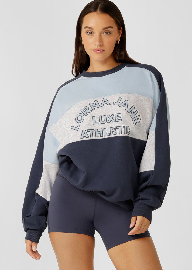 Stay cozy and stylish in this oversized sweat, featuring tonal color-blocked panels and statement logo embroidery. Perfect for lounging and running errands, this sweat is a must-have addition to your casual wardrobe, providing comfort and warmth when you need it most.