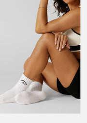 Elevate your Pilates practice with our Lotus Pilates Grip Crew Socks. The non-slip grip on the sole provides traction and stability, allowing you to confidently move through your workout. Made from breathable cotton blend yarn with our iconic lotus logo, you'll be reaching for these socks on repeat.