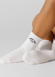 Elevate your Pilates practice with our Lotus Pilates Grip Crew Socks. The non-slip grip on the sole provides traction and stability, allowing you to confidently move through your workout. Made from breathable cotton blend yarn with our iconic lotus logo, you'll be reaching for these socks on repeat.
