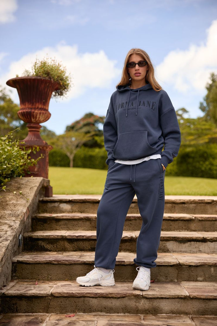 Spoil yourself with comfort in the Lounge Fleece Hoodie. Made from cosy brushed fleece fabric, this oversized pullover features pockets, tonal embroidered limited edition branding, and a hood with drawcord adjustability. This will be your go-to leisure piece when the weather starts to cool down!