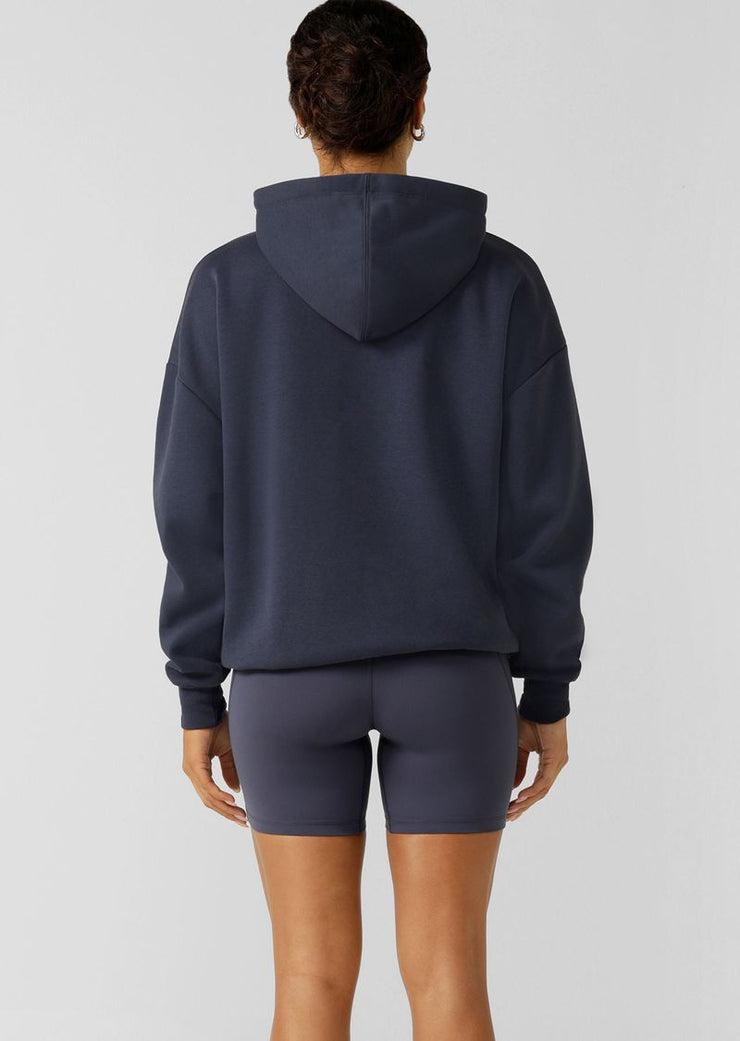 Spoil yourself with comfort in the Lounge Fleece Hoodie. Made from cosy brushed fleece fabric, this oversized pullover features pockets, tonal embroidered limited edition branding, and a hood with drawcord adjustability. This will be your go-to leisure piece when the weather starts to cool down!