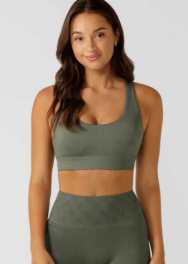 Elevate your workout game in this seamless sports bra. Designed for all day support, this bra offers a seamless fit that moves with you, while providing a stylish and unique look that will make you stand out in any class or crowd.