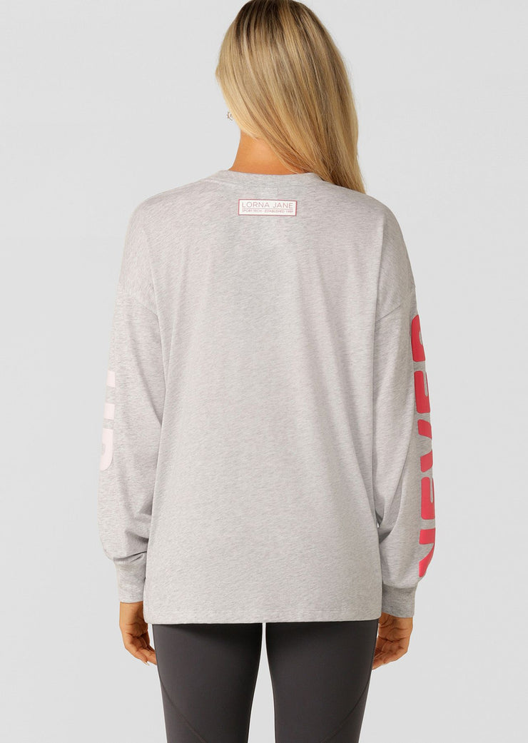 Meet your new versatile layering piece with the Never Give Up long sleeve relaxed fit tee. Crafted from lightweight and breathable cotton blend jersey, this oversized top features a limited edition inspirational puff print and is perfect for wearing back with your workout and weekend wardrobe.