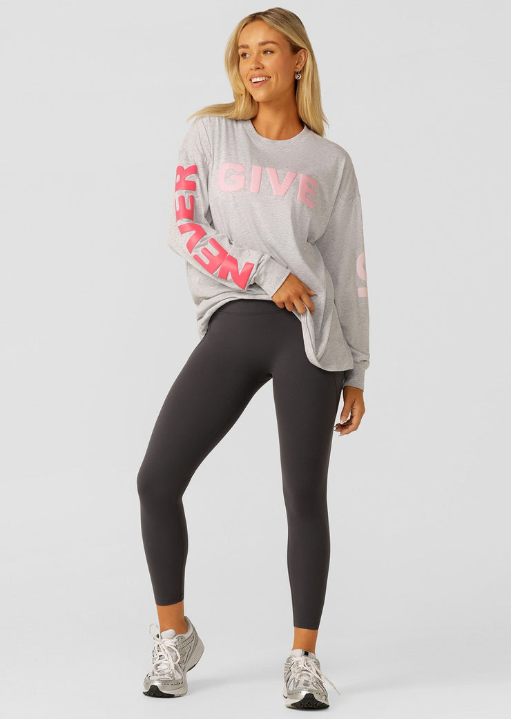 Meet your new versatile layering piece with the Never Give Up long sleeve relaxed fit tee. Crafted from lightweight and breathable cotton blend jersey, this oversized top features a limited edition inspirational puff print and is perfect for wearing back with your workout and weekend wardrobe.