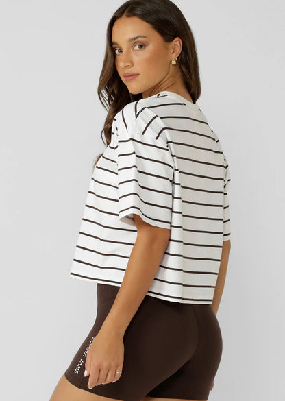 Wear Anywhere Wardrobe Essential
Cropped Oversize Fit
Premium Textured Cotton Slub Fabrication in a classic striped design
Classic Rib Contrast Crew Neckline
Limited Edition Logo Patch