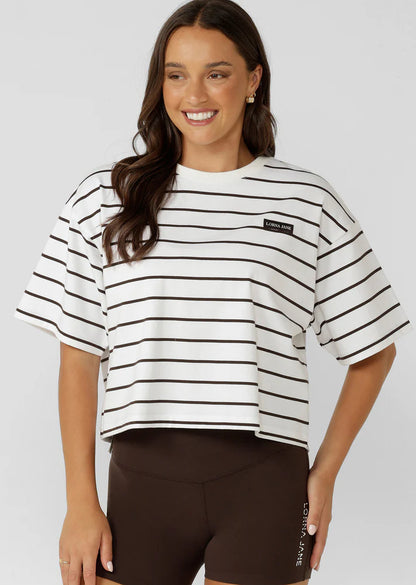 Wear Anywhere Wardrobe Essential
Cropped Oversize Fit
Premium Textured Cotton Slub Fabrication in a classic striped design
Classic Rib Contrast Crew Neckline
Limited Edition Logo Patch