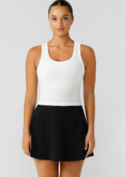 The perfect addition to your active and everyday wardrobe. This breathable cotton blend rib tank has a form-fitting mid length silhouette that is versatile enough to wear in and out of the gym and a scoop neckline perfect for layering over your sports bras