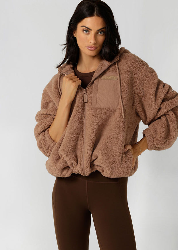 Make a statement in this stylish teddy zip through hoodie, the must-have addition to your athleisure wardrobe. Designed to keep you cosy, this hoodie features drawcord adjustability to trap in the warmth, a no-fuss zip-through opening, oversized silhouette and a multi pocket design, perfect for when the weather starts to cool down.
