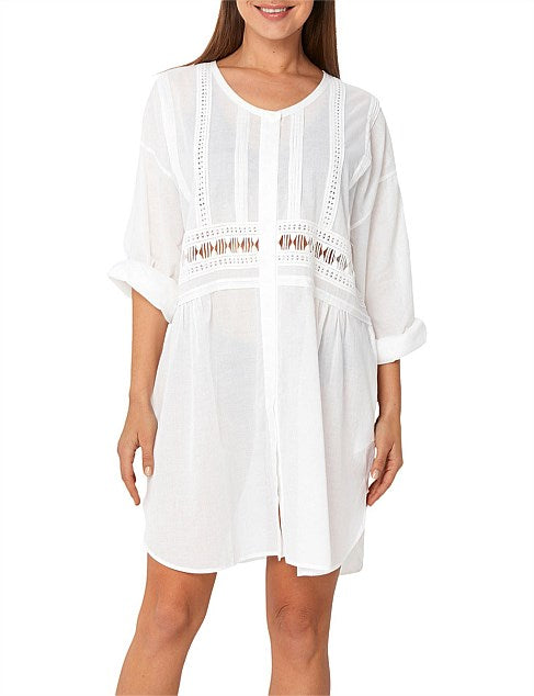 Monte and Lou Resort Shirt Dress is the perfect beach to bar cover-up. Comfortable and breathable soft cotton, team with some linen pants or shorts for everyday. - Features a concealed button through front opening. - Lace panel inserts in front and back waist. - Tuck detail on front bodice and waist. - Pockets in side seam - Detailed shaped hem - Cuff sleeve. - Generous loose fit