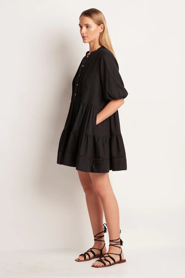 The ML Separates Tiered Mini Dress is designed for comfort and perfect for any holiday wardrobe.   Button front opening with pintuck detail and ladder inserts. Comfortable loose fit  Mid thigh length Side pockets Short blouson sleeve with elastic hem Dress length from Shoulder to hem on a size small is 90cm.