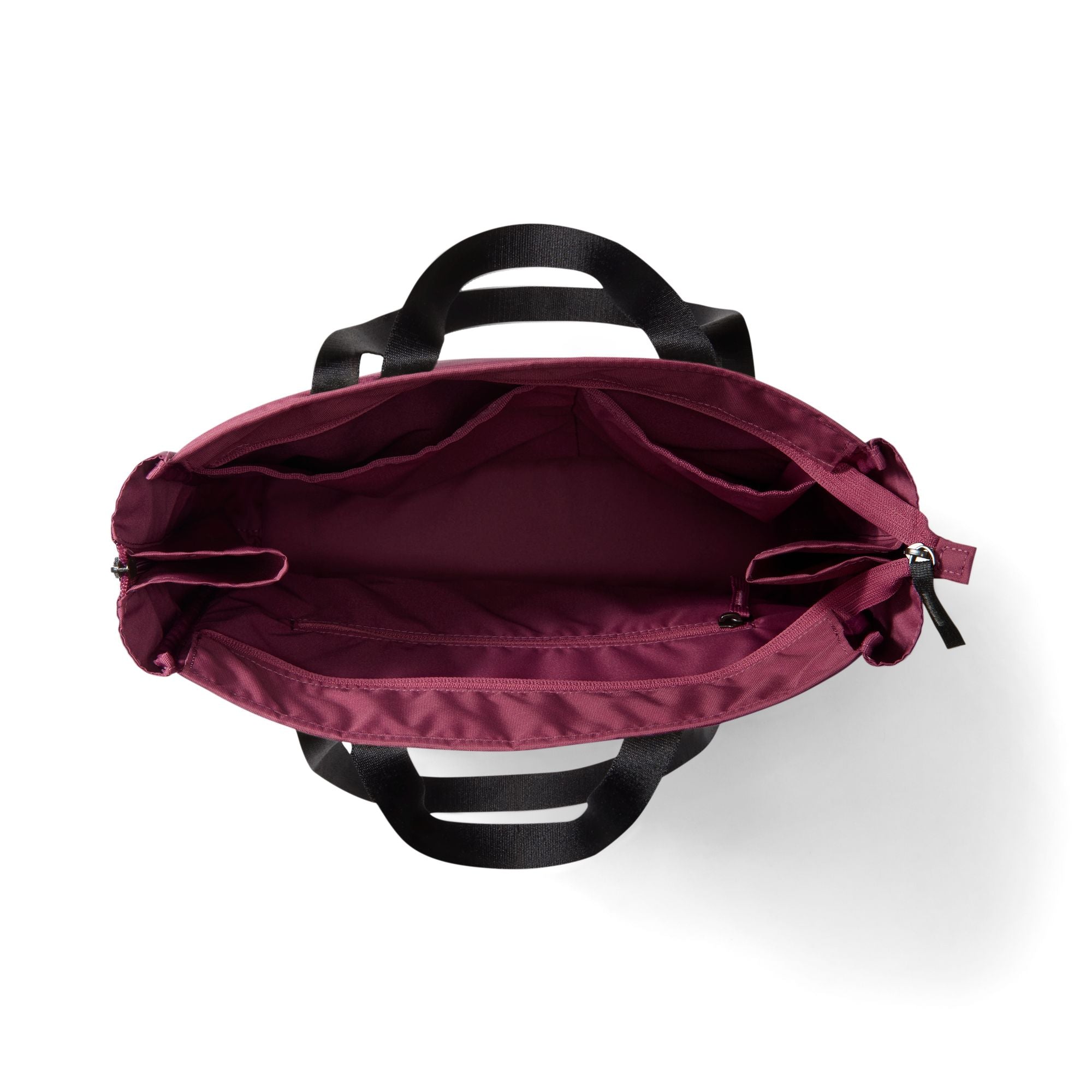 Top-down view of a burgundy tote bag with black handles, showing the interior compartments and zipper closure on a white background.