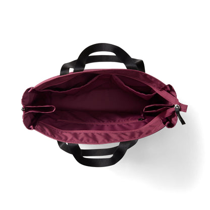 Top-down view of a burgundy tote bag with black handles, showing the interior compartments and zipper closure on a white background.