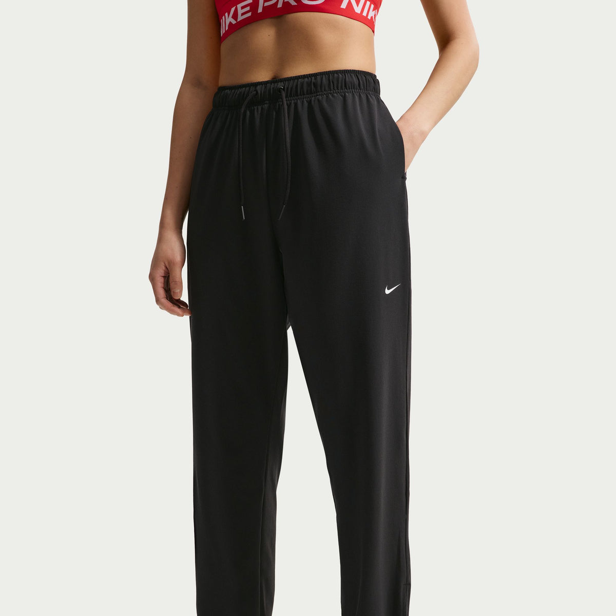 Nike Dri-FIT technology moves sweat away from your skin for quicker evaporation, helping you stay dry and comfortable.
Encased elastic waistband with drawcord secures your fit.
Hidden snaps at the pant cuffs offer an easy on and off experience.