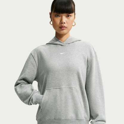 Person wearing a grey Nike hoodie on a white background