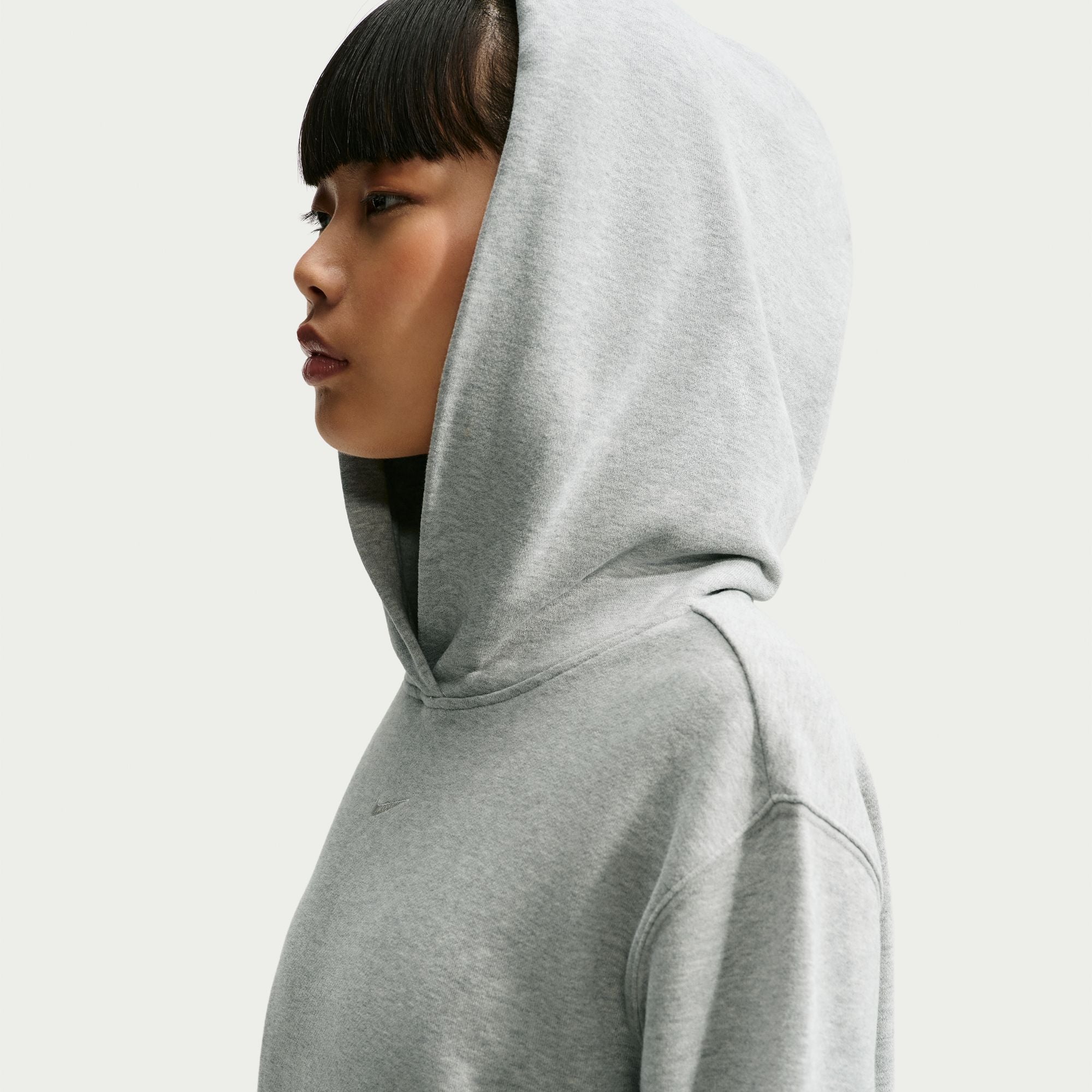 Person wearing a grey Nike hoodie 