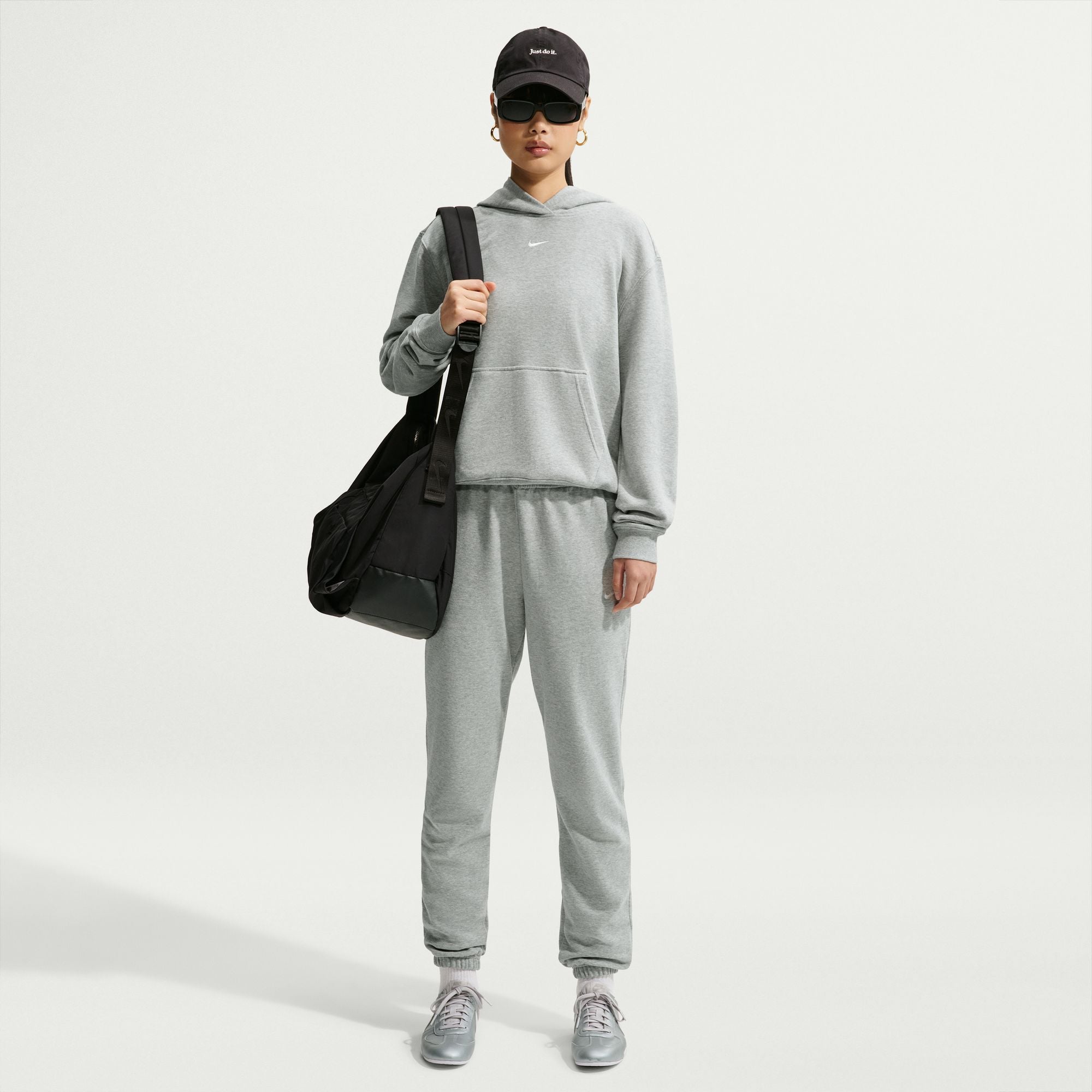 Person wearing a grey Nike hoodie 