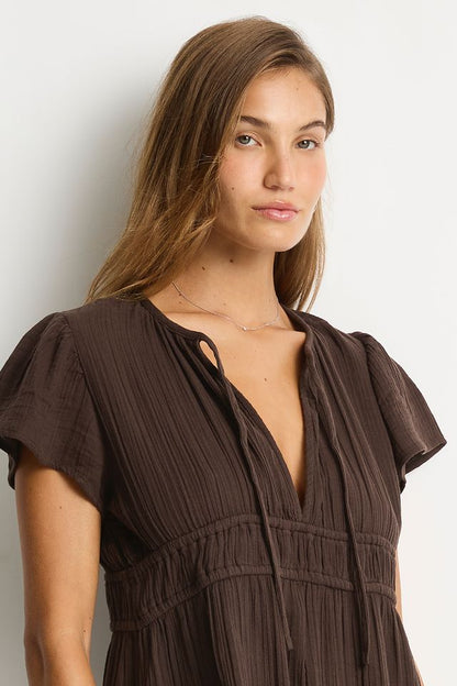 Cotton cheesecloth fabric
Soft touch fabric
V front neckline with tie
Elastic underbust panel
Short fluted sleeve