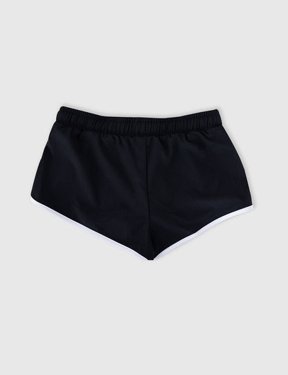 Seafolly Girls Essentials Boardshort in Black features an elasticated waistband, draw cord, scallop hemline, contrast piping.