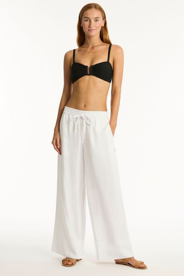 Elastic and pull cord waist tie Side pockets High waisted with wide leg Hem band detail
